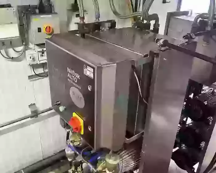 Rear view of custom stainless steel replacement tank installed on a Nilfisk Delta Booster multi-pump pressure washer system.